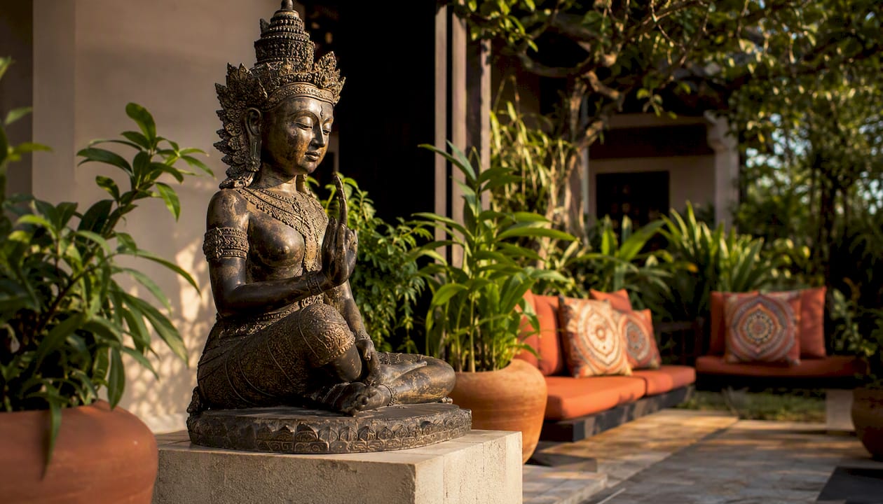 Asian sculpture on pedestal in boutique hotel lobby