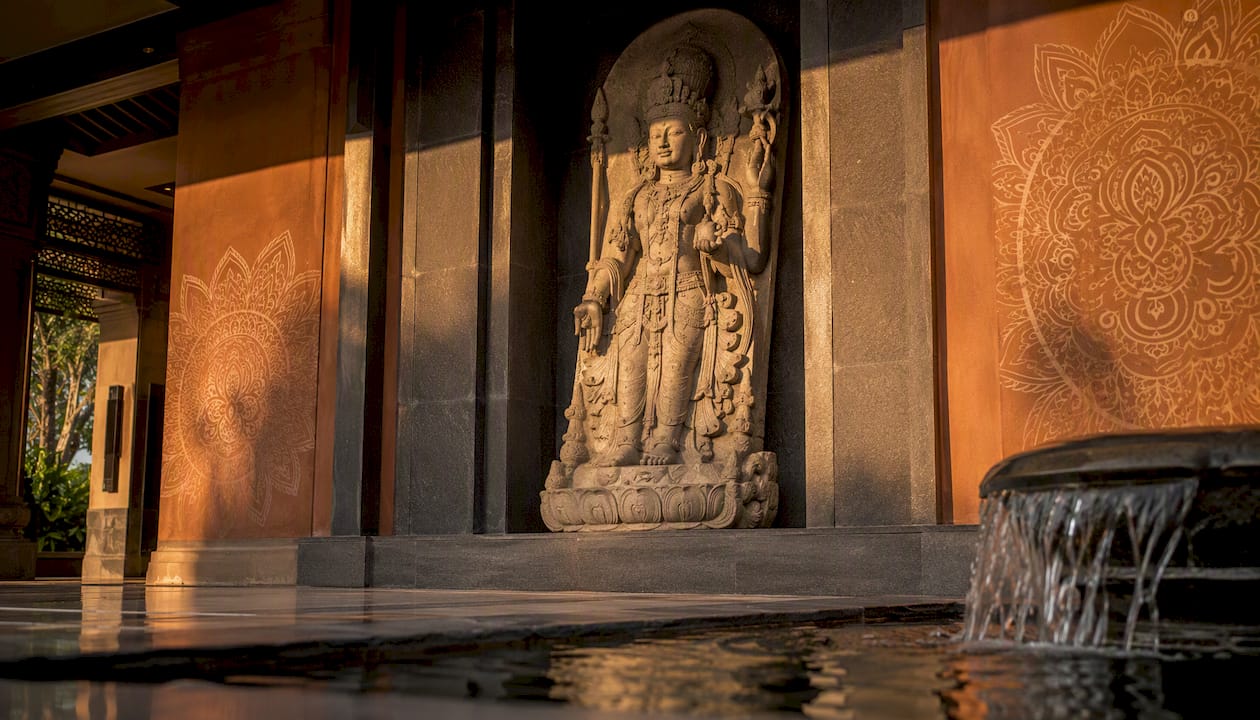 Resort lobby with carved stone Buddha statue